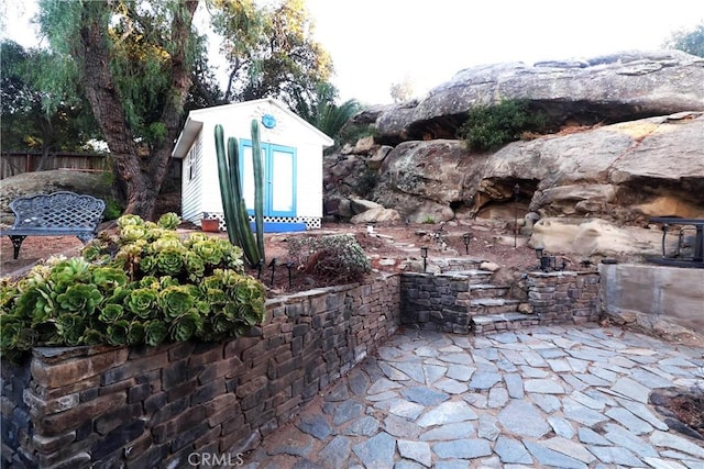 view of patio featuring a storage shed