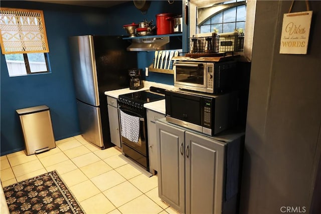 kitchen featuring light tile patterned floors, black / electric stove, open shelves, light countertops, and under cabinet range hood