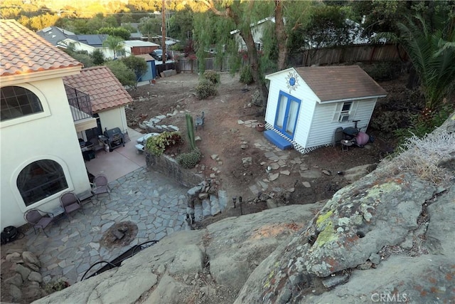 view of yard with an outdoor structure, a patio area, and fence