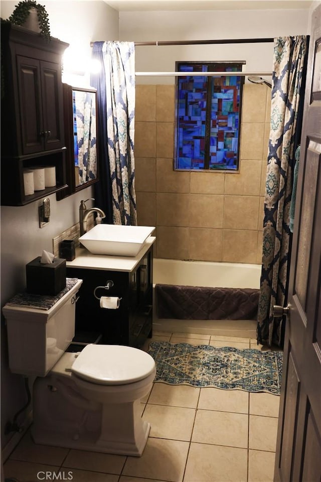 bathroom featuring tile patterned flooring, toilet, vanity, and shower / bath combo