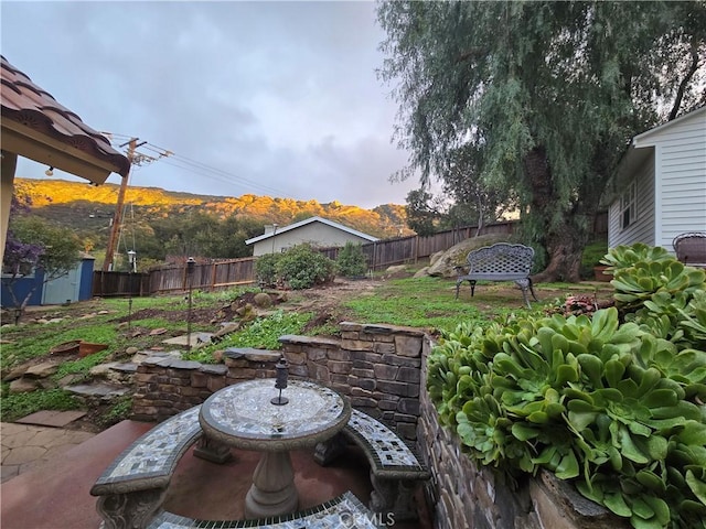 view of yard featuring an outbuilding and a fenced backyard