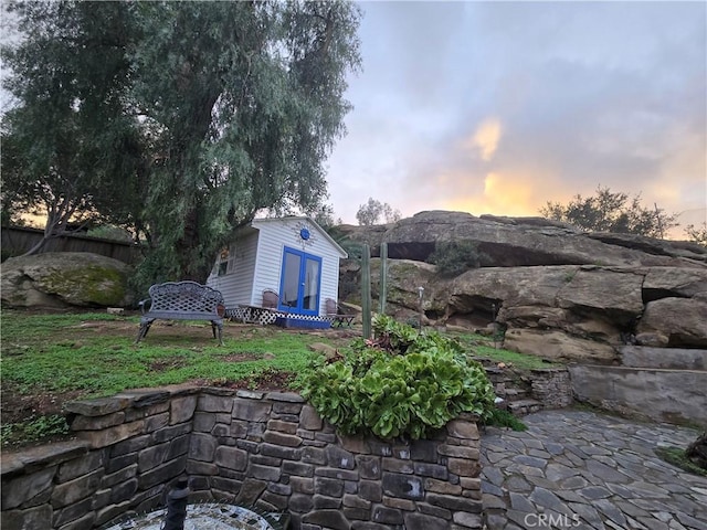 view of patio with an outdoor structure and fence