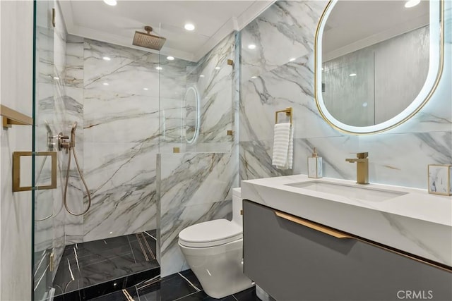 bathroom with vanity, tile walls, toilet, and tiled shower