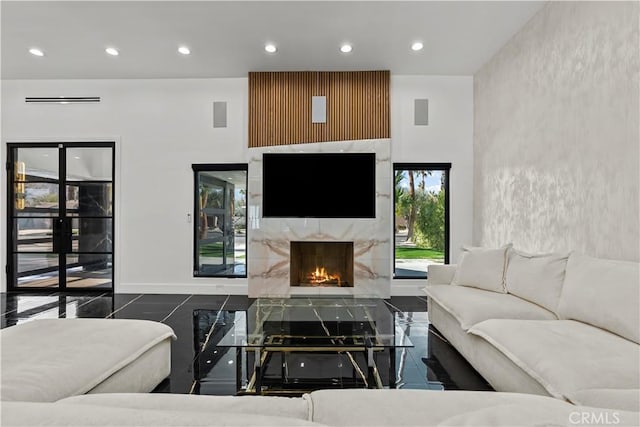 living room with a high end fireplace