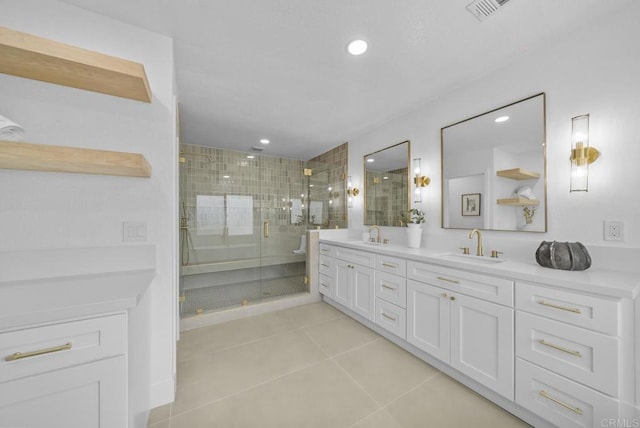 bathroom featuring tile patterned floors, vanity, and a shower with shower door