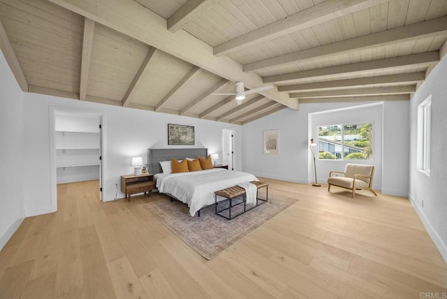 bedroom featuring wood ceiling, light hardwood / wood-style flooring, ceiling fan, vaulted ceiling with beams, and a walk in closet