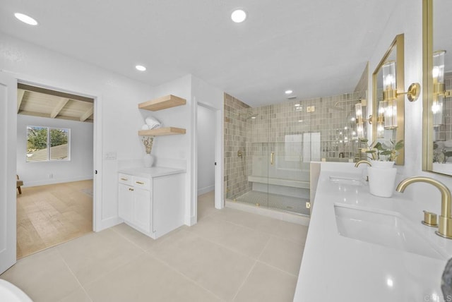 bathroom with walk in shower, vanity, and tile patterned flooring