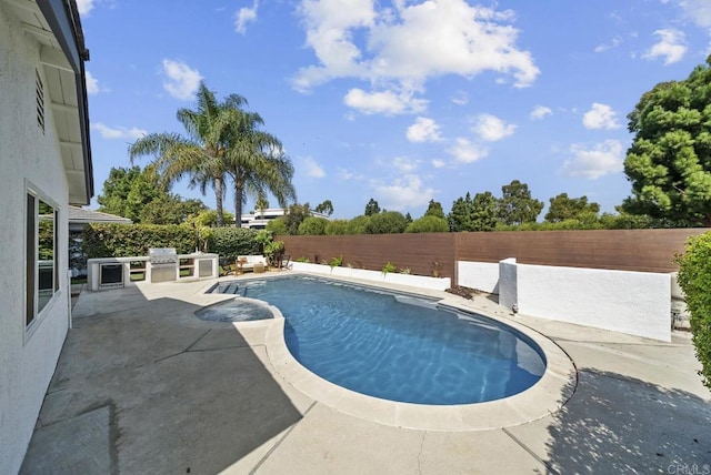 view of swimming pool featuring a patio area, grilling area, and exterior kitchen