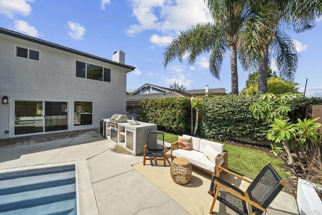 view of patio with outdoor lounge area and an outdoor kitchen