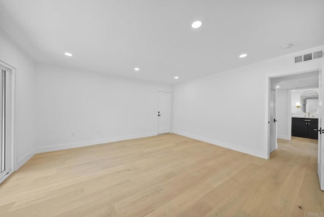 unfurnished room with light hardwood / wood-style floors