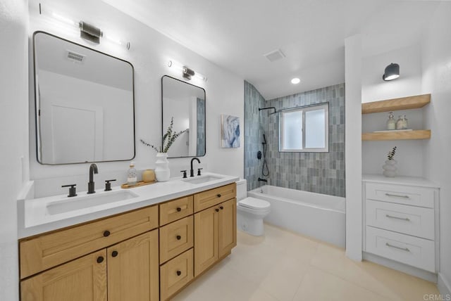 full bathroom with tiled shower / bath, vanity, and toilet