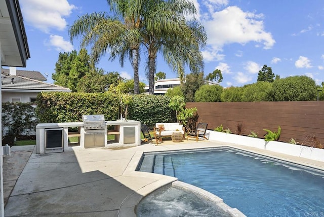 view of swimming pool with area for grilling, an outdoor hangout area, a patio, and an outdoor kitchen