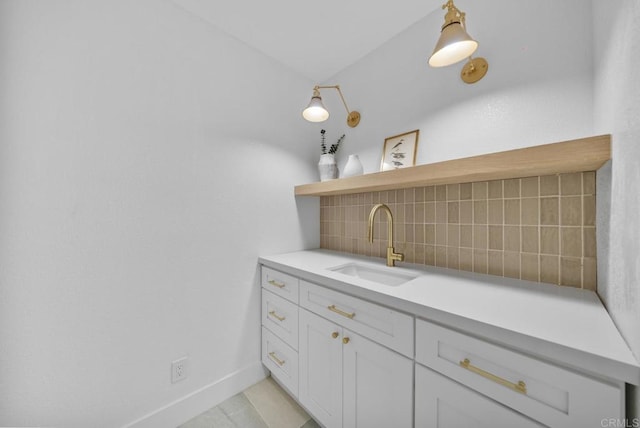 bathroom featuring tasteful backsplash and sink