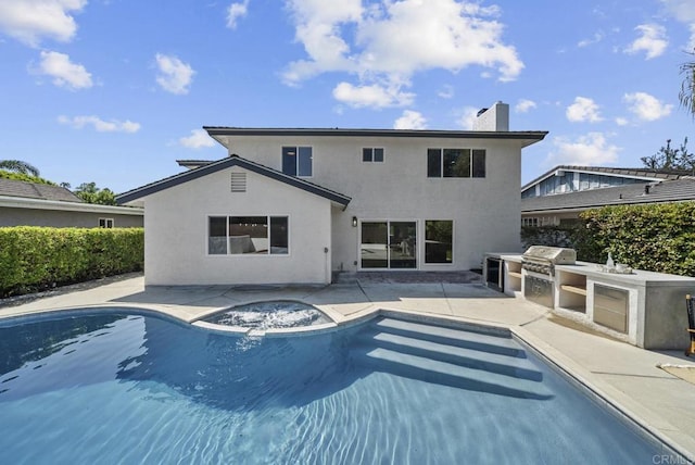 rear view of property with area for grilling and a patio area