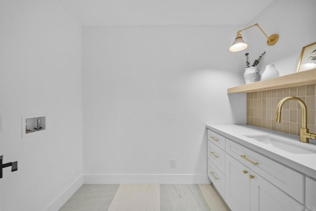 interior space with sink and backsplash