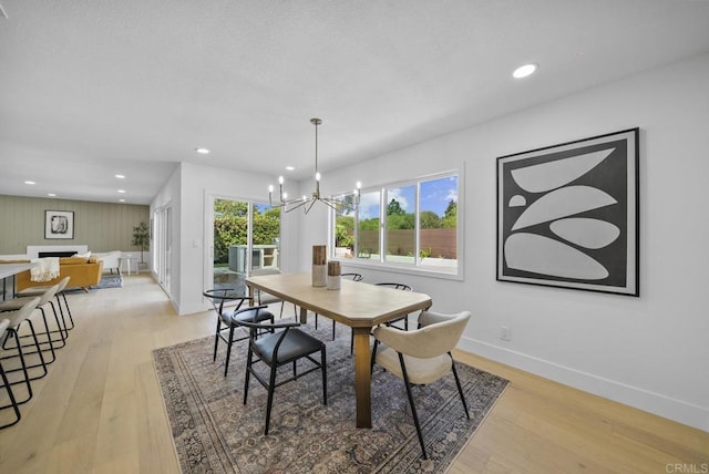 dining space with a chandelier and light hardwood / wood-style floors