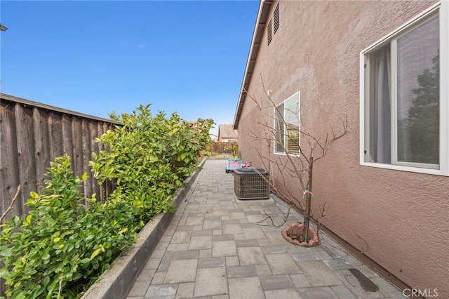 view of property exterior featuring cooling unit and a patio area