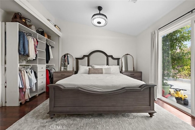 bedroom featuring lofted ceiling, dark wood-type flooring, access to outside, and a closet