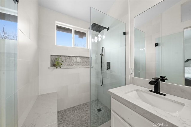 bathroom featuring vanity and tiled shower