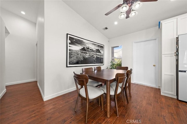 dining room featuring vaulted ceiling, dark hardwood / wood-style floors, and ceiling fan