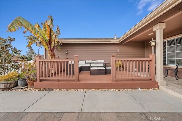 wooden deck featuring an outdoor living space and a patio