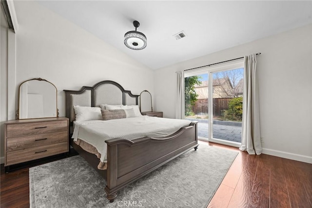 bedroom featuring vaulted ceiling, access to outside, and dark hardwood / wood-style flooring