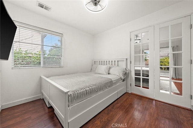 bedroom with dark hardwood / wood-style floors