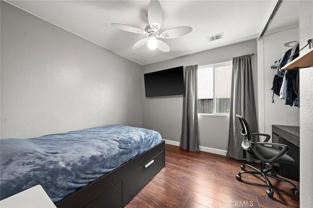 bedroom featuring ceiling fan and dark hardwood / wood-style flooring