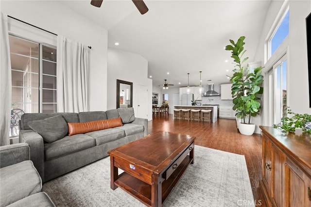 living room with dark hardwood / wood-style floors and ceiling fan