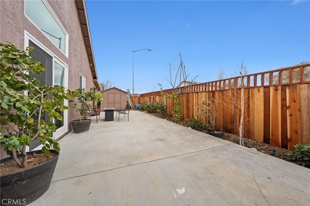 view of patio featuring a shed