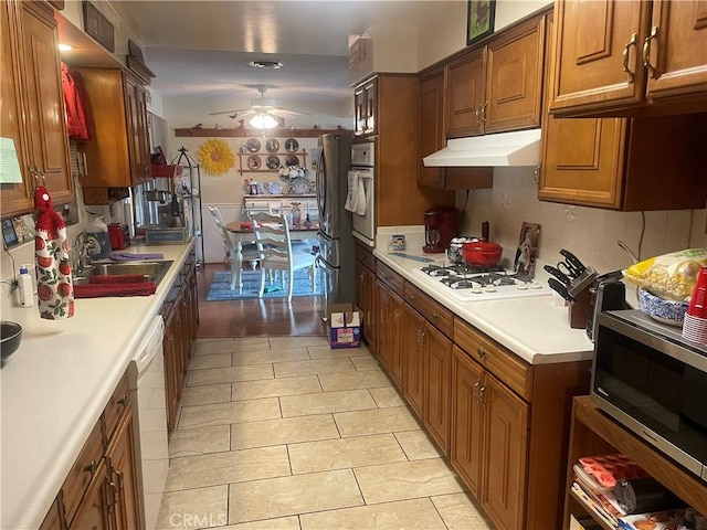 kitchen with sink, light tile patterned floors, ceiling fan, and appliances with stainless steel finishes