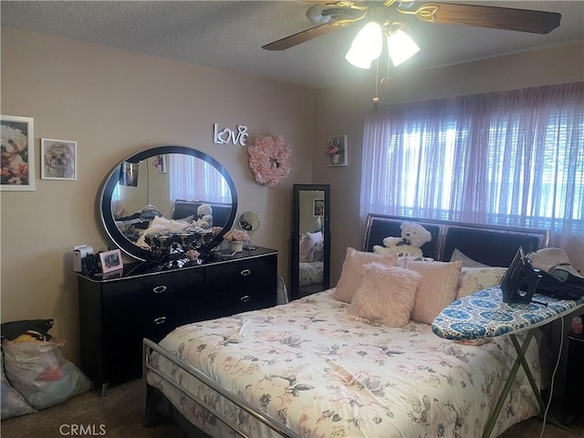 bedroom with carpet flooring, a textured ceiling, and ceiling fan