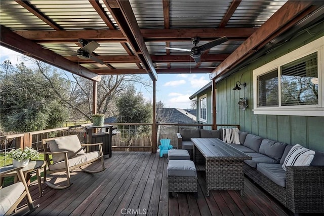 wooden terrace with ceiling fan and outdoor lounge area