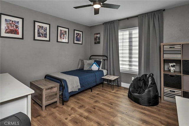 bedroom featuring dark hardwood / wood-style floors and ceiling fan