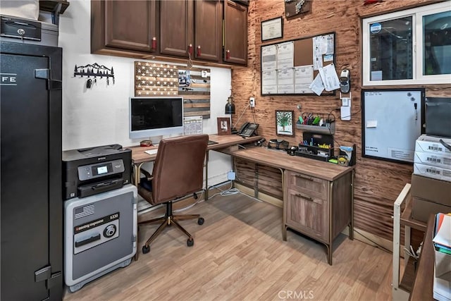 home office with light hardwood / wood-style flooring