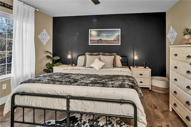 bedroom with dark wood-type flooring