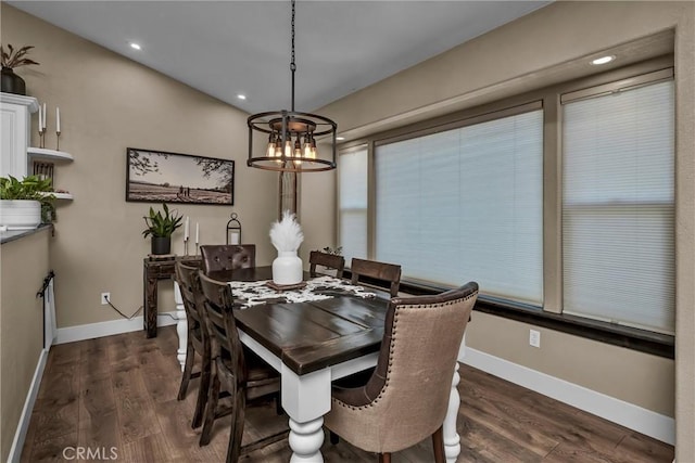 dining area with dark hardwood / wood-style flooring and a notable chandelier