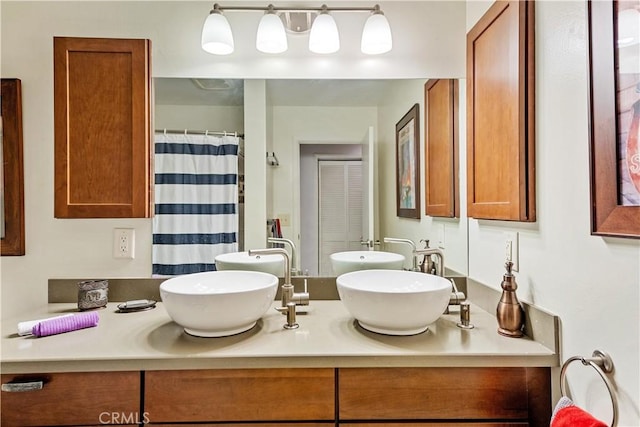 bathroom featuring vanity and curtained shower