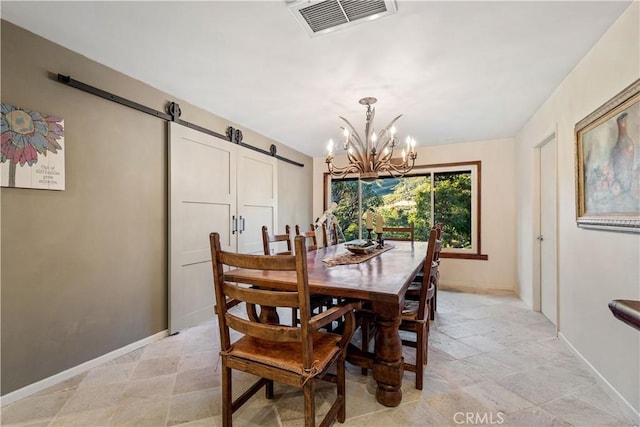 dining space featuring a barn door and an inviting chandelier