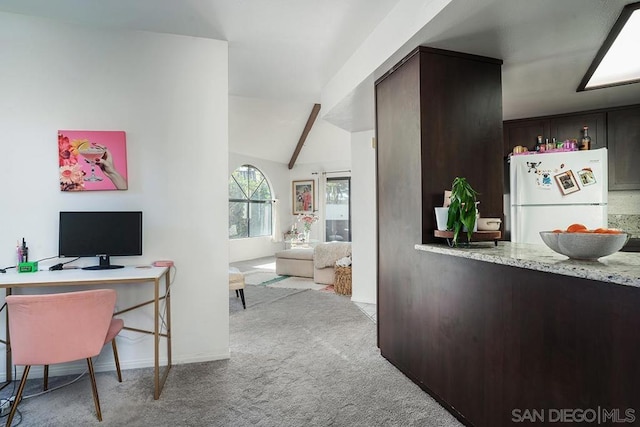 carpeted office with lofted ceiling