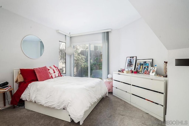 carpeted bedroom with lofted ceiling