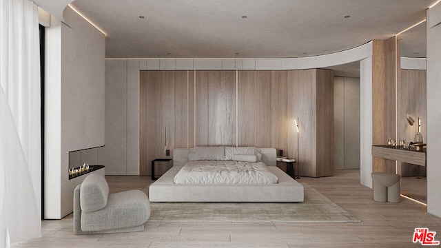 bedroom with wooden walls and light wood-type flooring