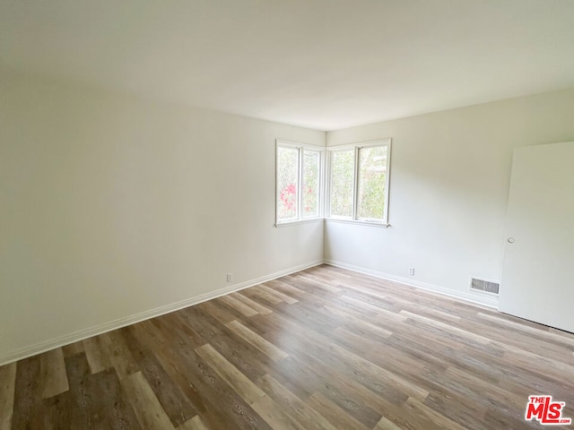 spare room with light hardwood / wood-style flooring