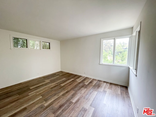 spare room with dark wood-type flooring