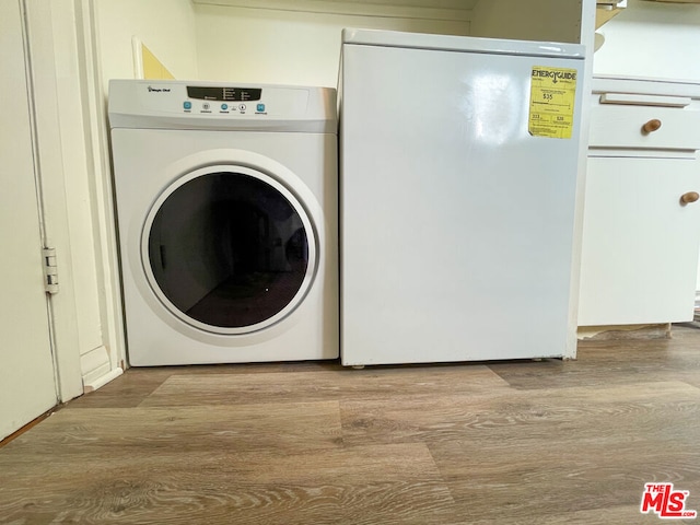 washroom with washer / dryer and light hardwood / wood-style floors