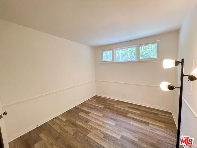 spare room with wood-type flooring