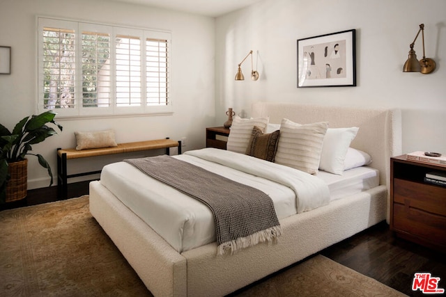 bedroom with dark wood-type flooring