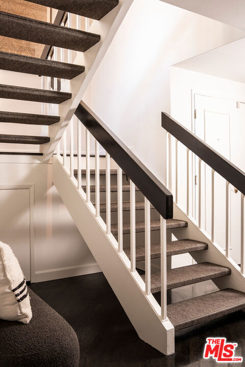 stairway with hardwood / wood-style flooring