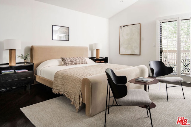 bedroom with lofted ceiling and wood-type flooring