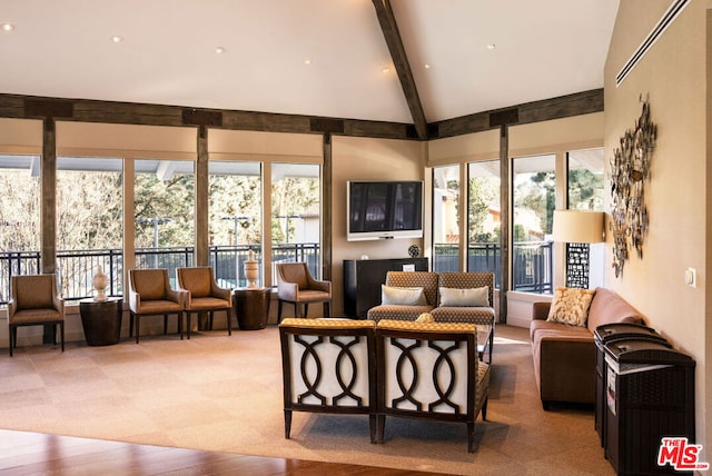 sunroom / solarium featuring lofted ceiling with beams